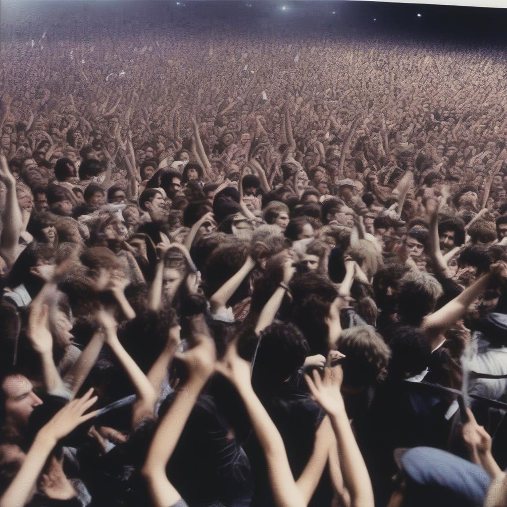 A crowd of Alphaville fans at a concert in the 1980s, cheering and singing along to the music.