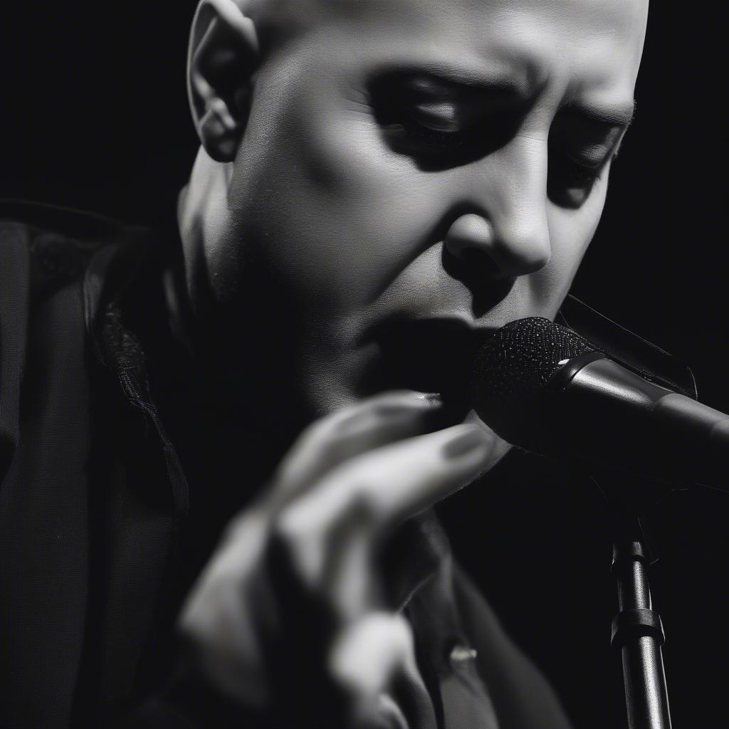 David Draiman singing into a microphone with passion