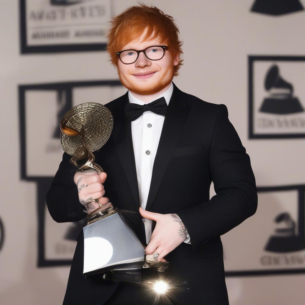 Ed Sheeran Receiving an Award -  Accepting an award on a stage, dressed in formal attire