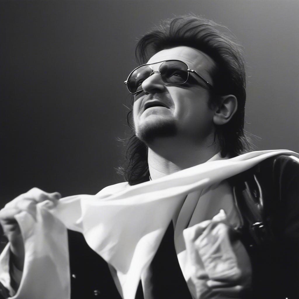 U2 passionately performing "Sunday Bloody Sunday" with Bono holding a white flag